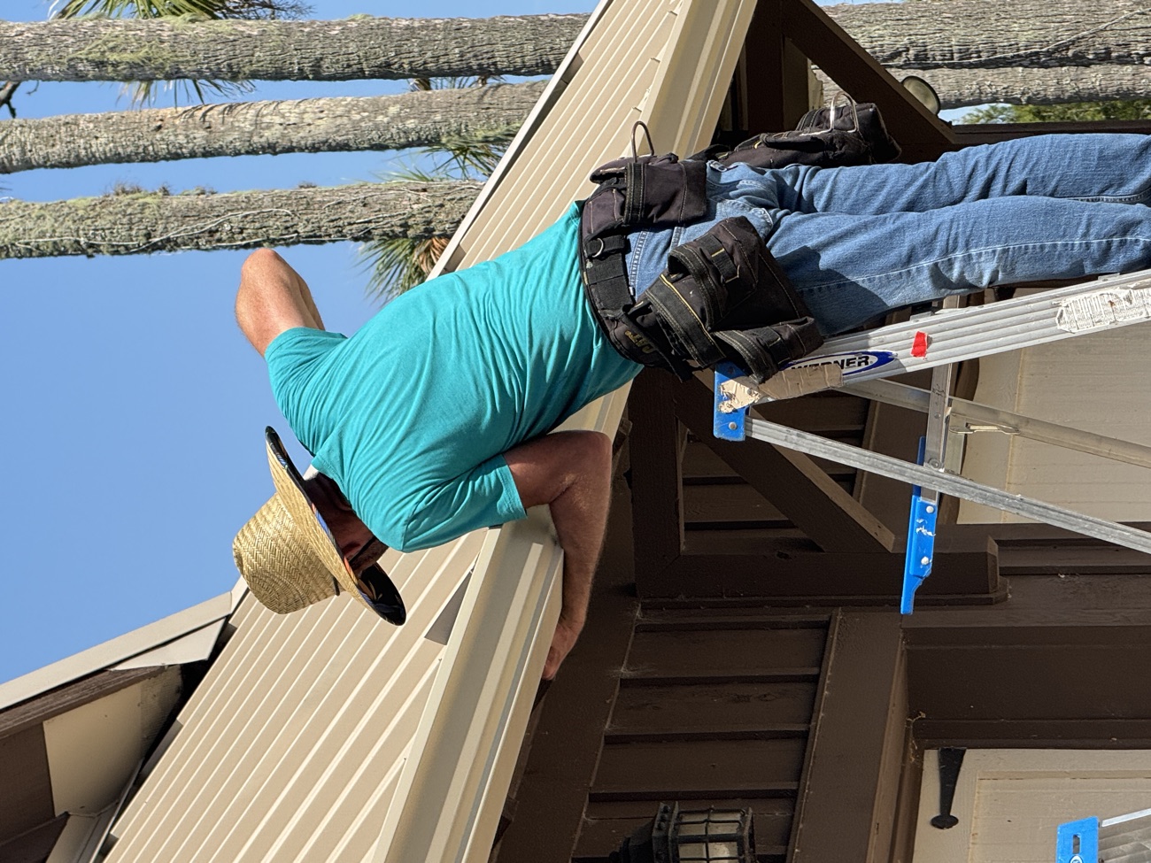 Aqua Premier technician servicing gutters on a Northeast Florida home