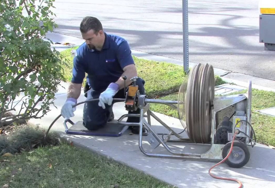 Technician clearing a clogged drain line with a jetter in Middleburg