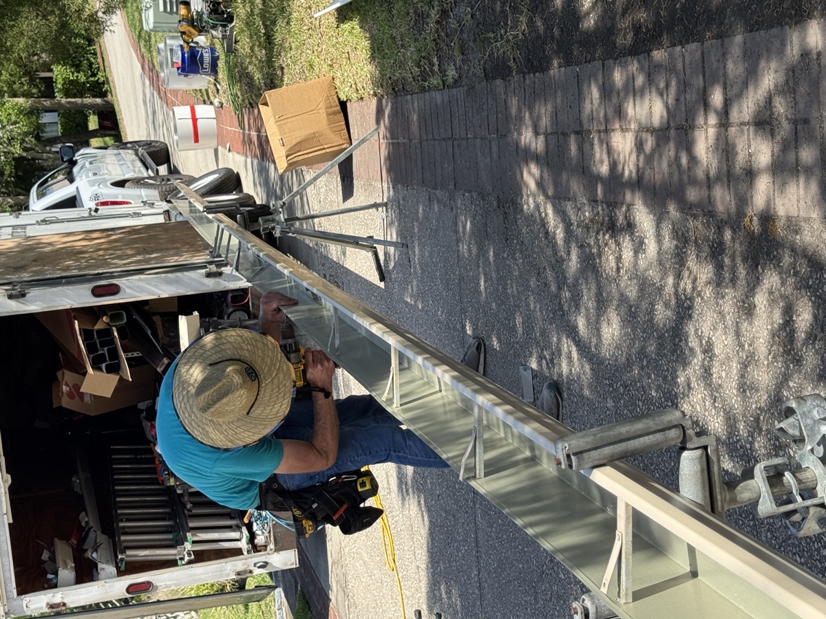 Aqua Premier technician custom-fabricating a seamless rain gutter on-site from a single continuous aluminum coil at the truck in Ponte Vedra Beach (32082)